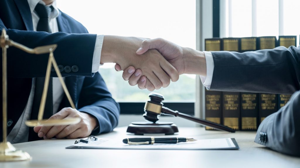 Handshake after Lawyer providing legal consult business dispute service to the man at the office