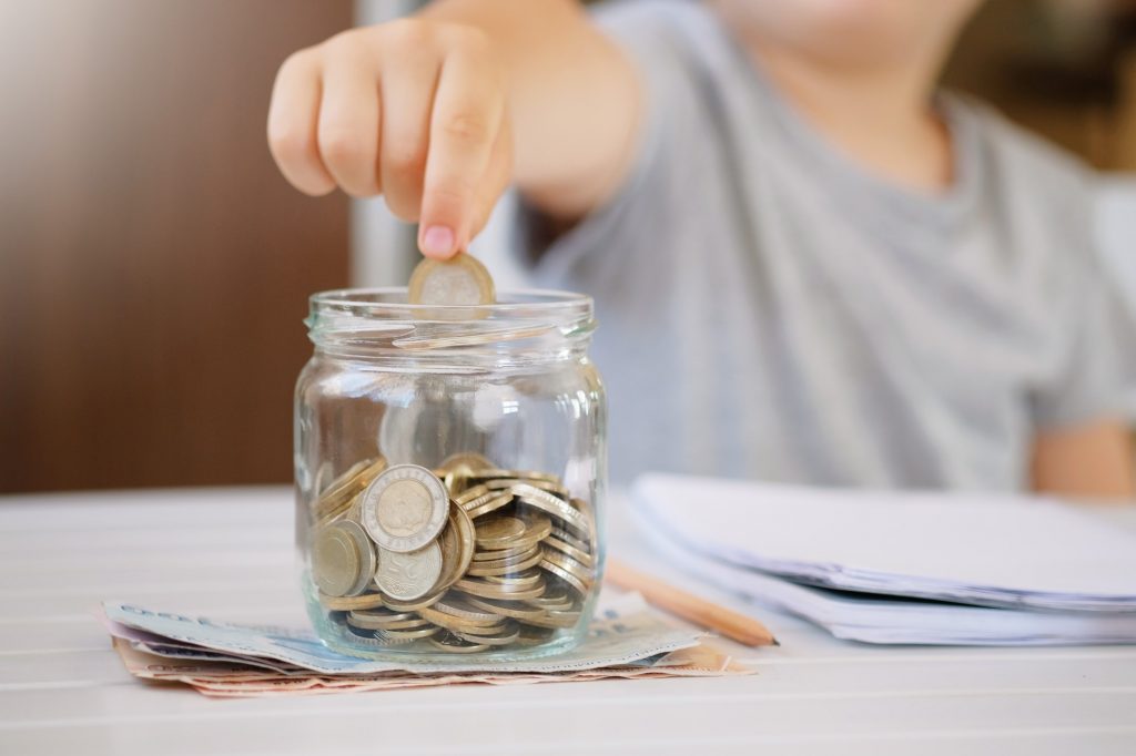 Kid Save money and account banking for finance concept. Turkish lira coins in glass jar and banknote